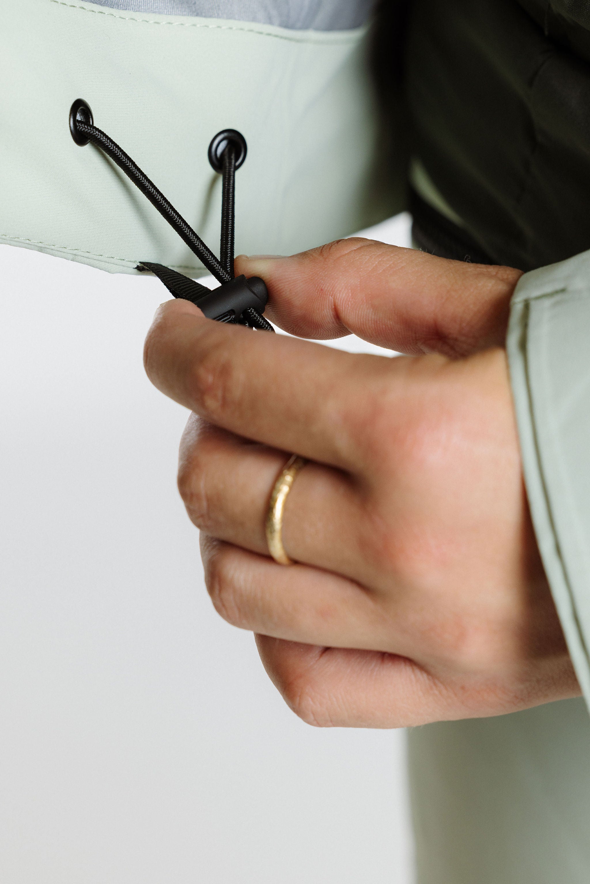 Enjo_3layershelljacket_women_softsage_insidedrawcordadjustment