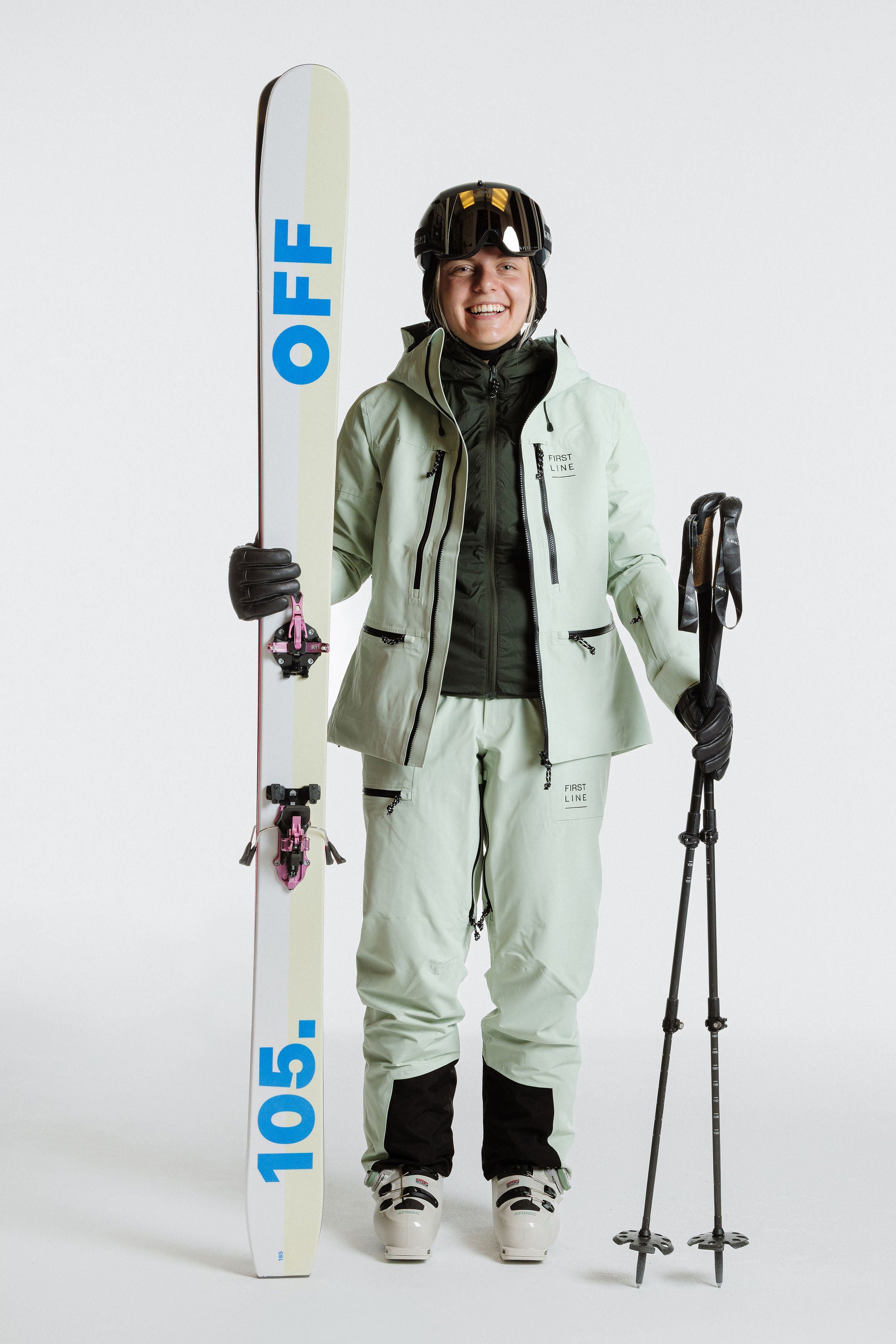 Enjo_3layershelljacket_women_softsage_frontview_with skis